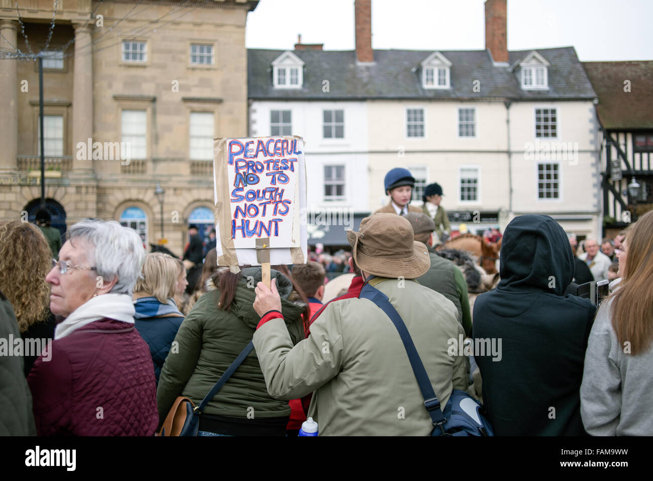 Newark-On-Trent.01st January 2015.Large crowds turned out on new years day morning for the annual South Notts hunt meeting. They gathered in Newarks market square before setting off in to the Nottinghamshire countryside. One lone protester with placard attended 'Laurence Goff'  he staged a peaceful protest . Credit:  Ian Francis/Alamy Live News Stock Photo