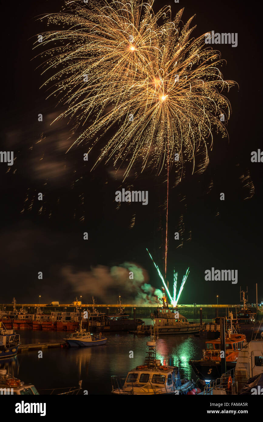 New Year Eve firework display at Ramsgate Royal Harbour with the commercial fleet in the foreground. Stock Photo