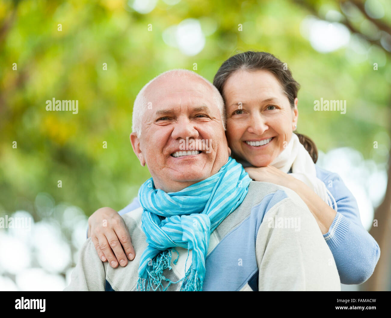 Portrait of cheerful senior couple together in autumn park Stock Photo ...