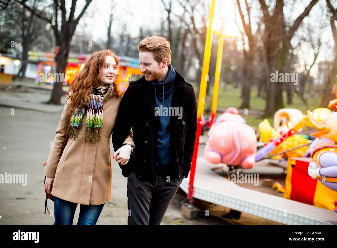 Young couple in the amusement park Stock Photo - Alamy