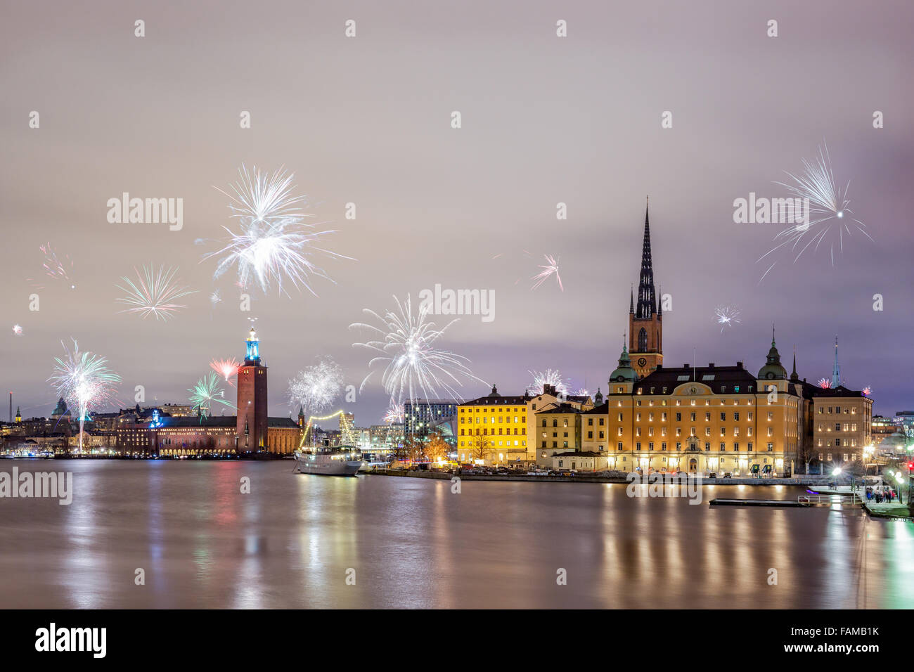 Stockholm, Sweden – Jan 1, 2016: New Year Fireworks are popping across Stockholm islands and city hall on Jan 1 in Stockholm. Stock Photo