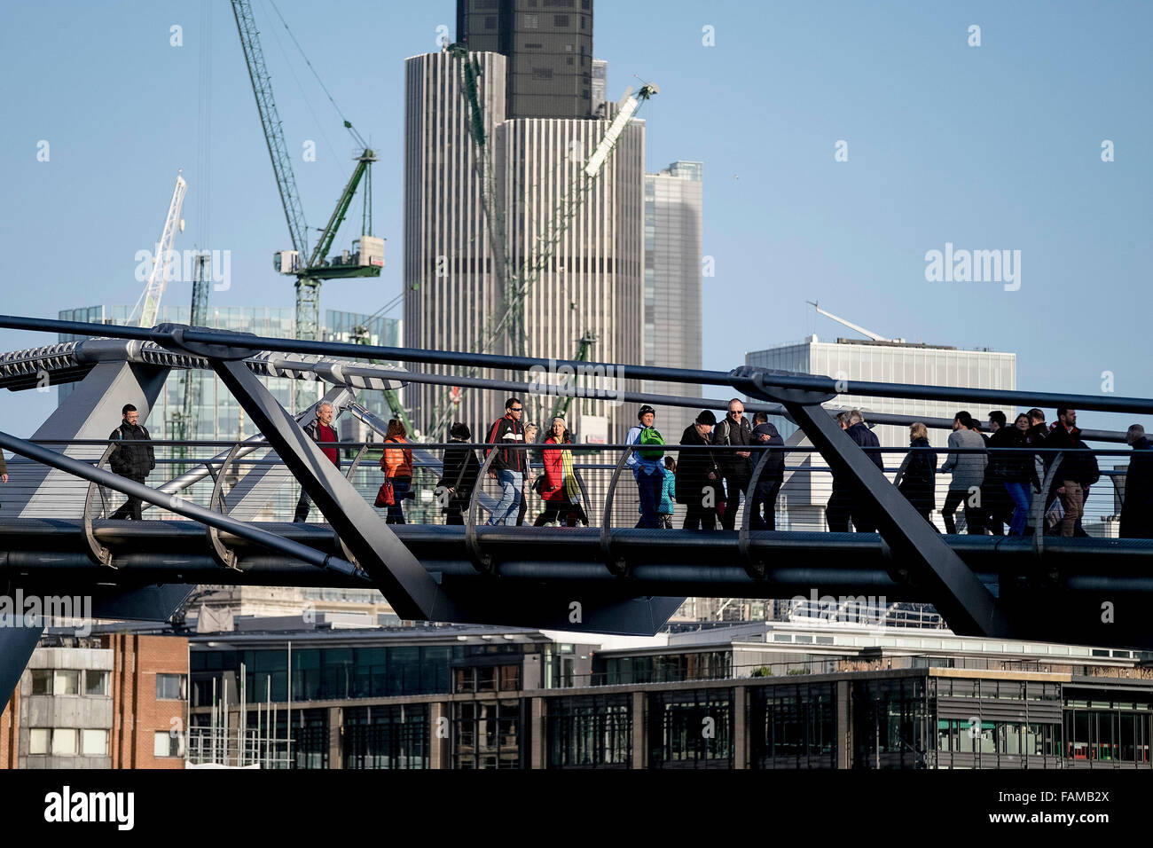 People cross on the Millenium Bridge in London. Stock Photo