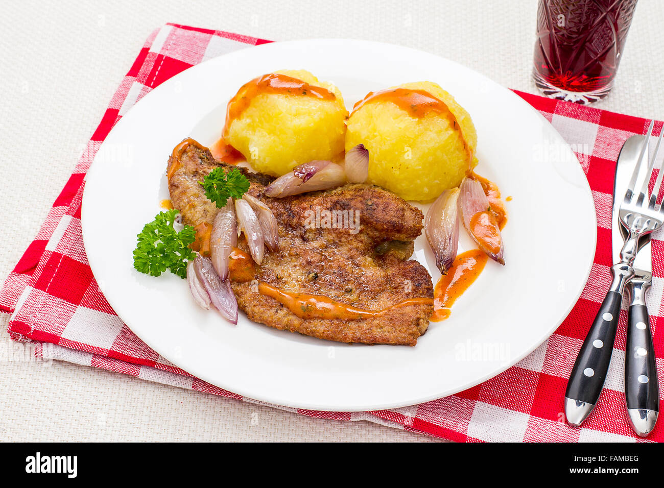 Roast veal liver with shallots and potato dumplings, top view Stock Photo