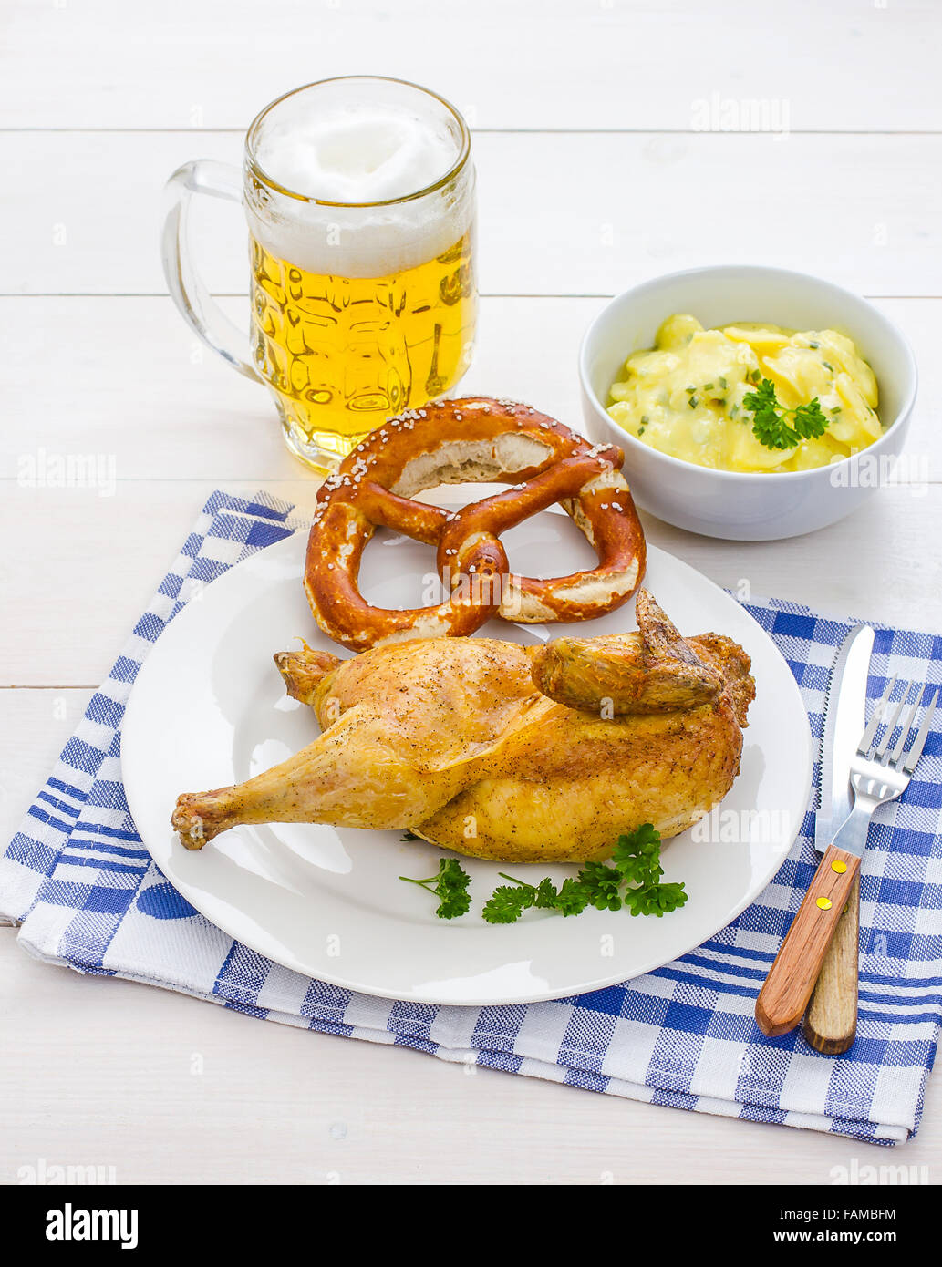 Half roast chicken, beer, pretzel and potato salad, Oktoberfest dinner
