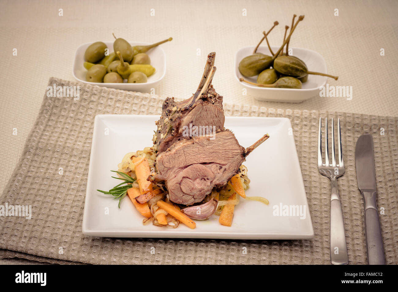 Grilled rack of lamb with carrot onion, garlic and rosemary Stock Photo