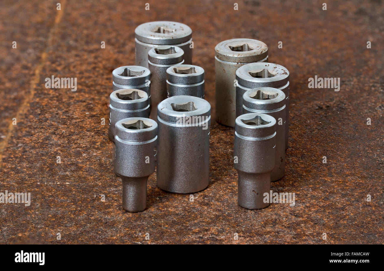 Closeup on socket wrench parts placed on at rusty steel plate Stock Photo Alamy