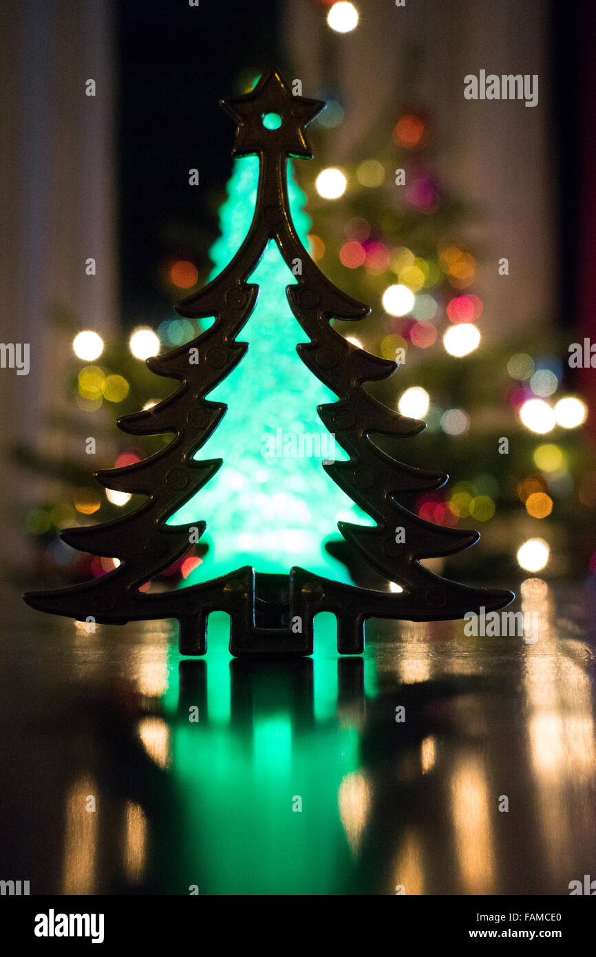 metal christmas tree with real tree in back Stock Photo