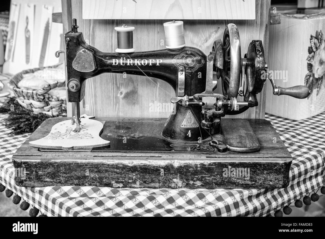 Old manual sewing machine used to embroider wooden shapes. Stock Photo