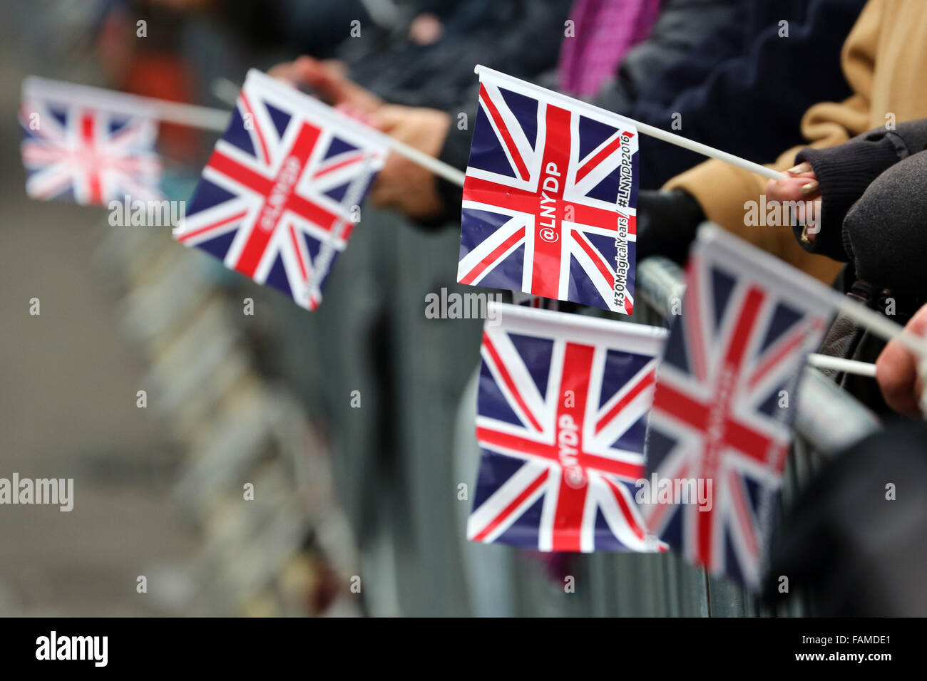 London, UK. 1st January 2016. LNYDP union jack flags waved by spectators at the London New Year's Day Parade, London, England which saw more than 8,500 performers from 20 countries worldwide taking part. With competitions between the London Boroughs and American marching bands and many, many horses it was certainly a great spectacle to start the year. Credit:  Paul Brown/Alamy Live News Stock Photo