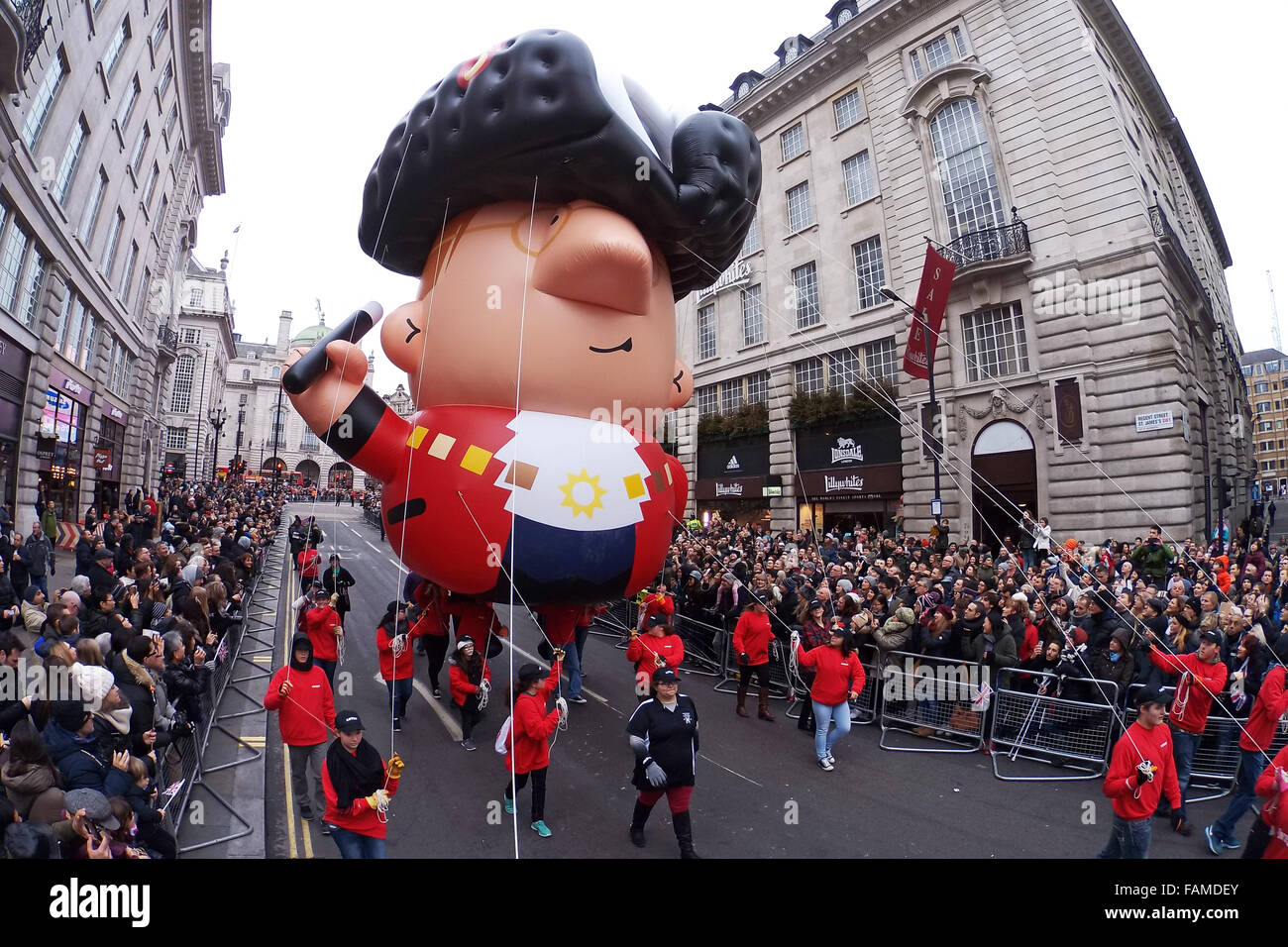 London, UK. 1st January 2016. A giant inflatable Town Crier is led ...