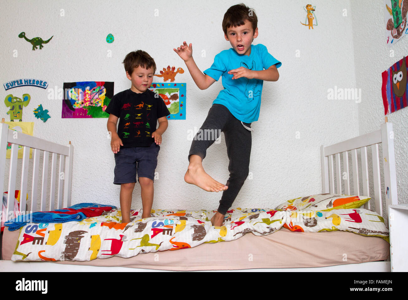 Boys jumping on bed Stock Photo