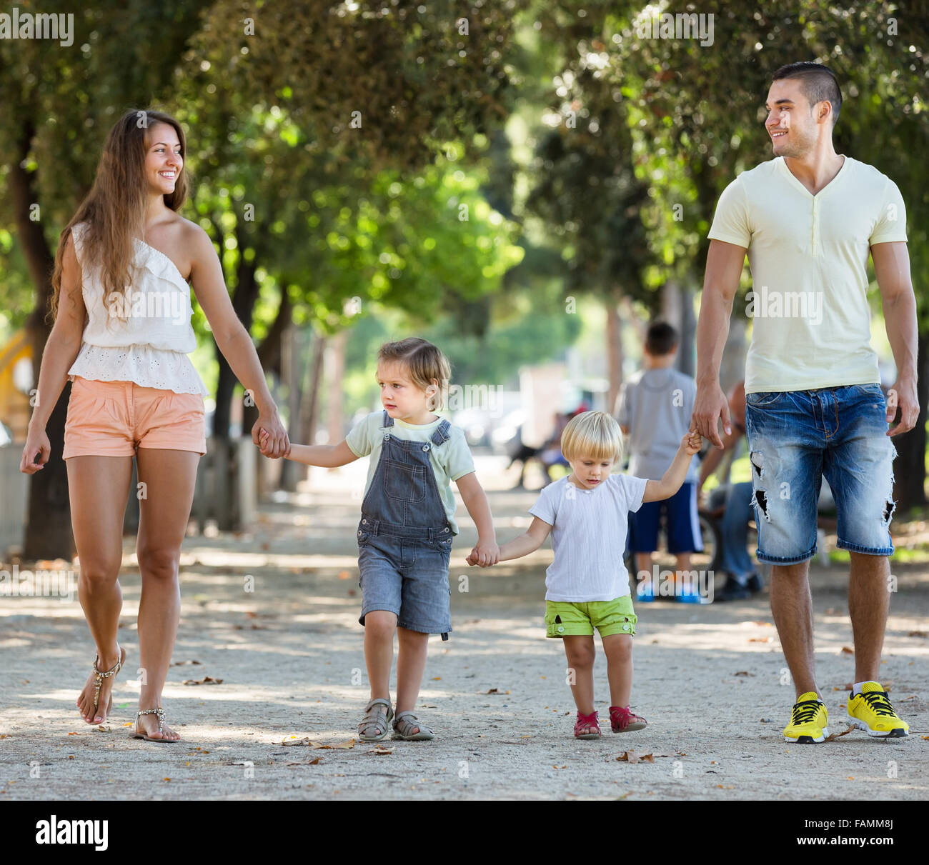 Happy family with childrens playing at park Stock Photo - Alamy
