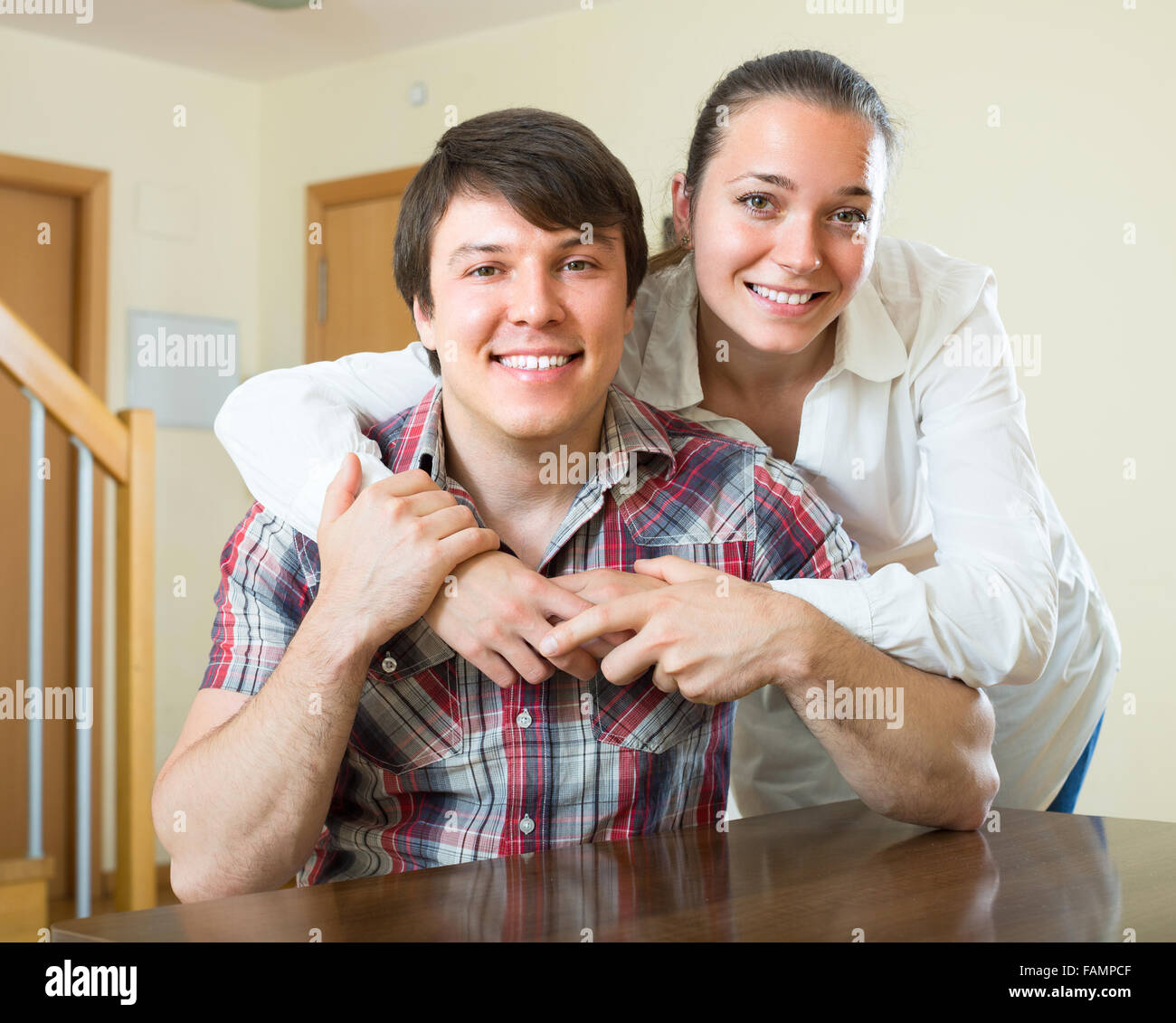 Young couple hugging home hi-res stock photography and images - Alamy
