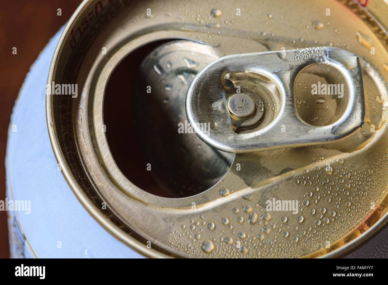 Closeup shot from the pull ring on a beverage can, opened aluminum can with water drop Stock Photo