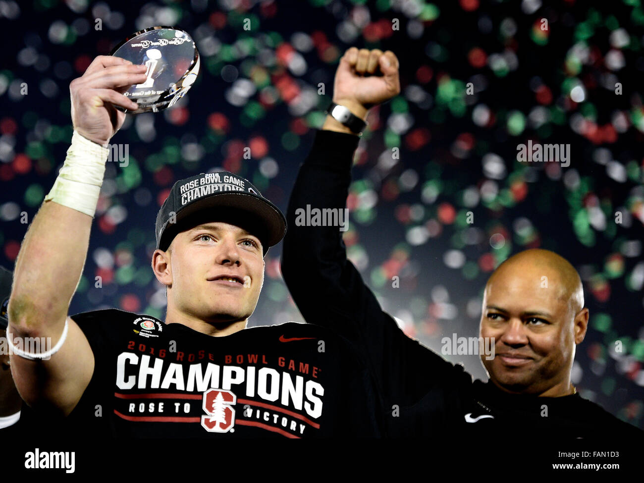 Pasadena, California, USA. 01st Jan, 2016. Stanford running back Christian McCaffrey, holds-up the MVP trophy as head coach David Shaw celebrates after Stanford defeated Iowa 45-16 during the 102nd Rose Bowl game in Pasadena, California on Friday, January 1, 2016. (Photo by Keith Birmingham/ Pasadena Star-News) Credit:  San Gabriel Valley Tribune/ZUMA Wire/Alamy Live News Stock Photo
