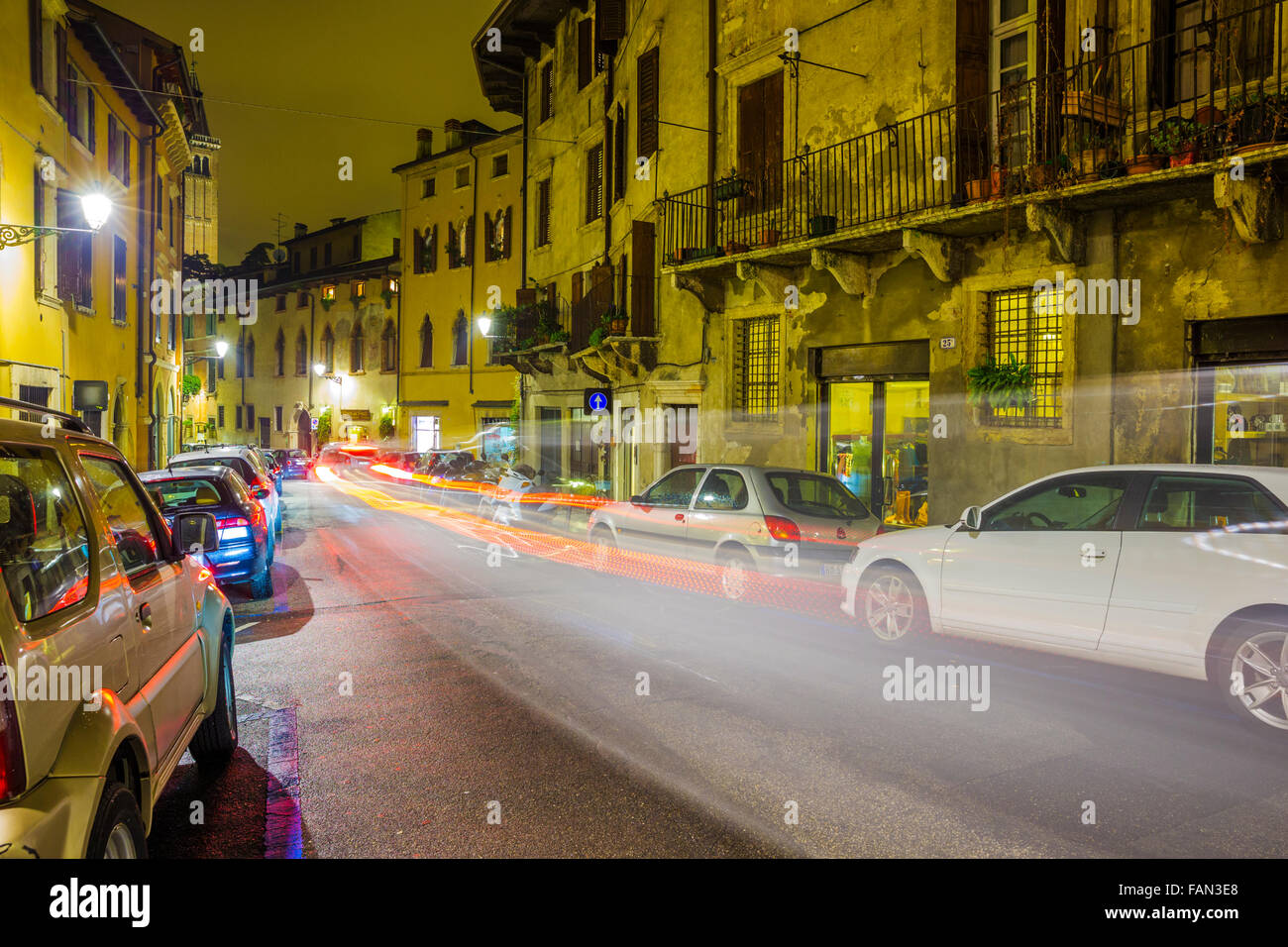 Via Garibaldi at dusk in rain with passing car, Verona Stock Photo - Alamy