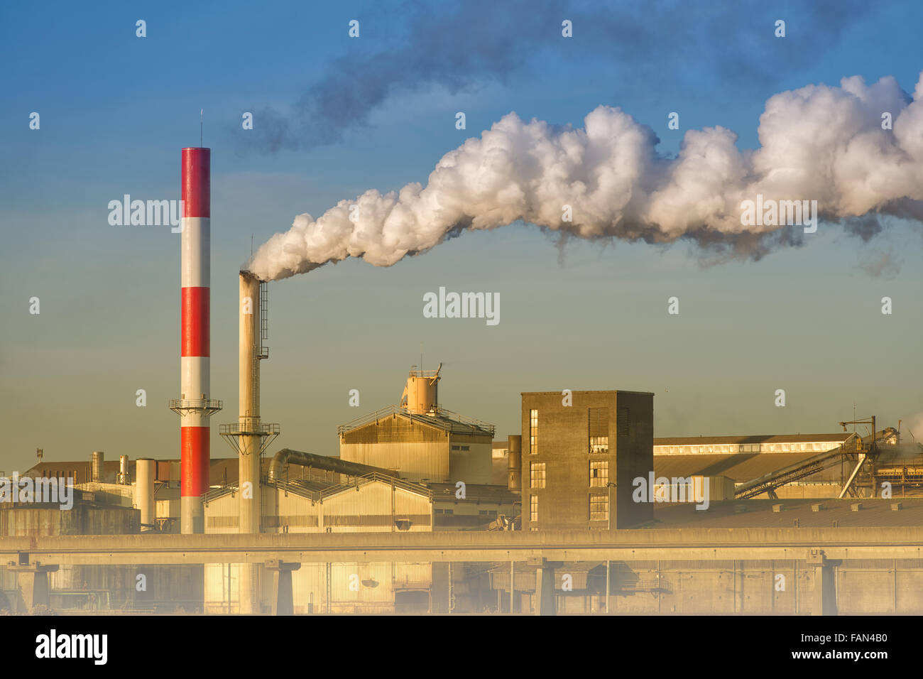 pollution of a factory with smog and chimney smoke Stock Photo