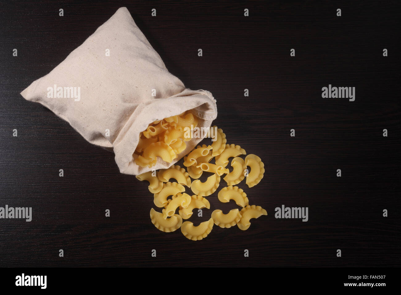 full lenght of the pasta pour from sack Stock Photo