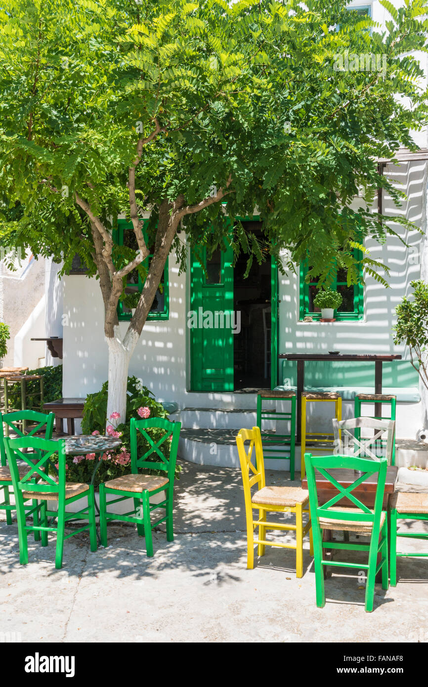 Tree shaded cafe tables and chairs, Folegandros, Greece Stock Photo