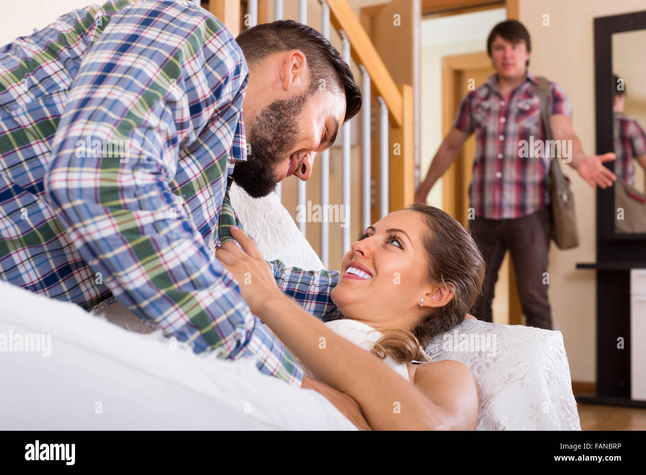 cheating spouse coming home and saw unfaithful woman Stock Photo
