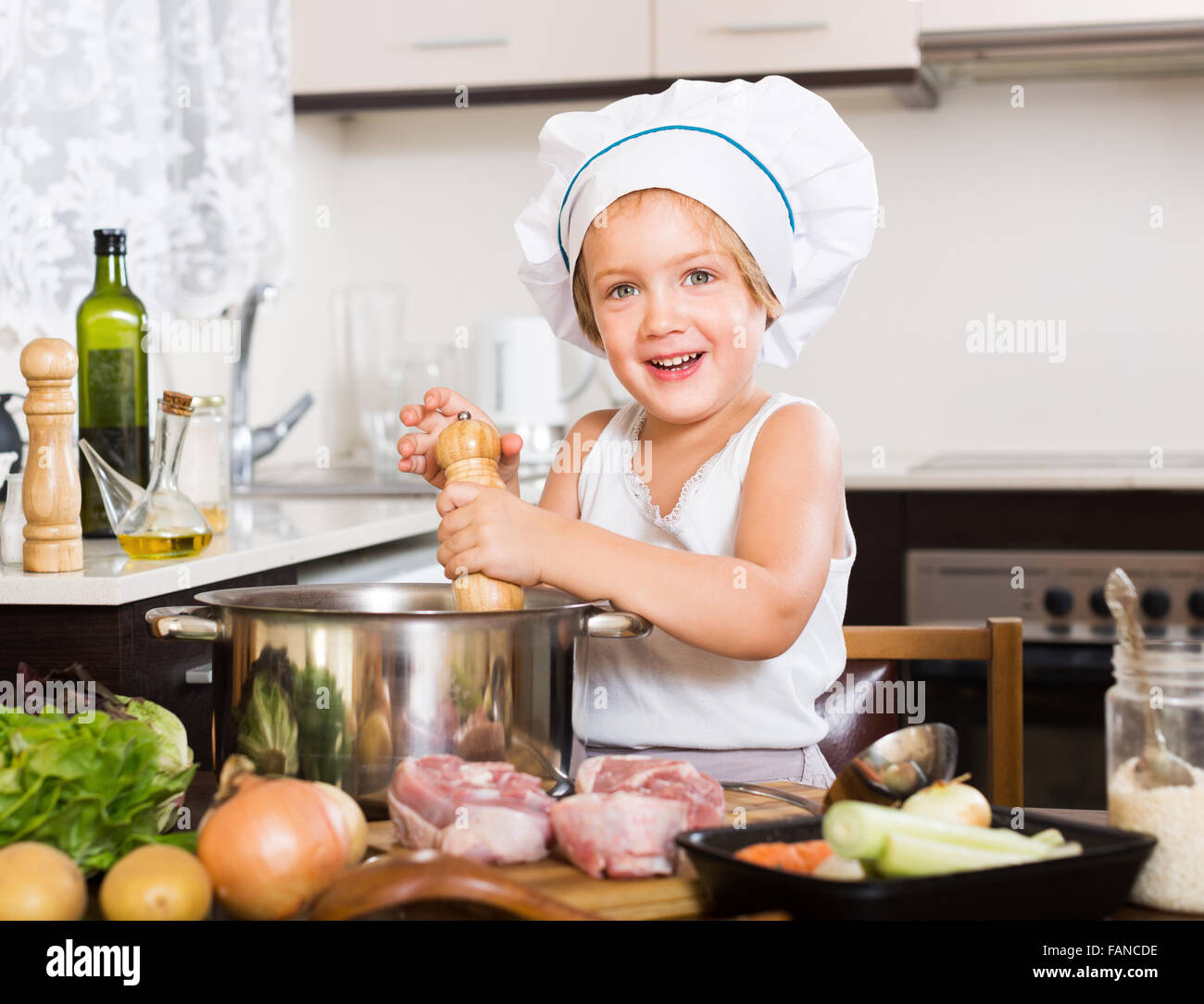 Smiling girl cooking soup at kitchen Stock Photo - Alamy