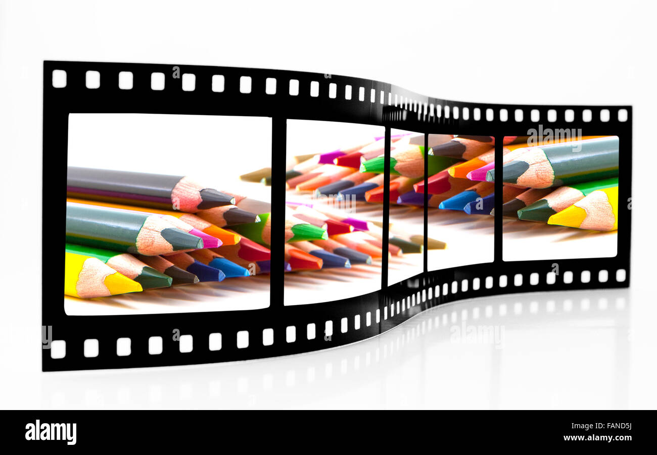 Film Strip with Coloured crayons on a white background Stock Photo