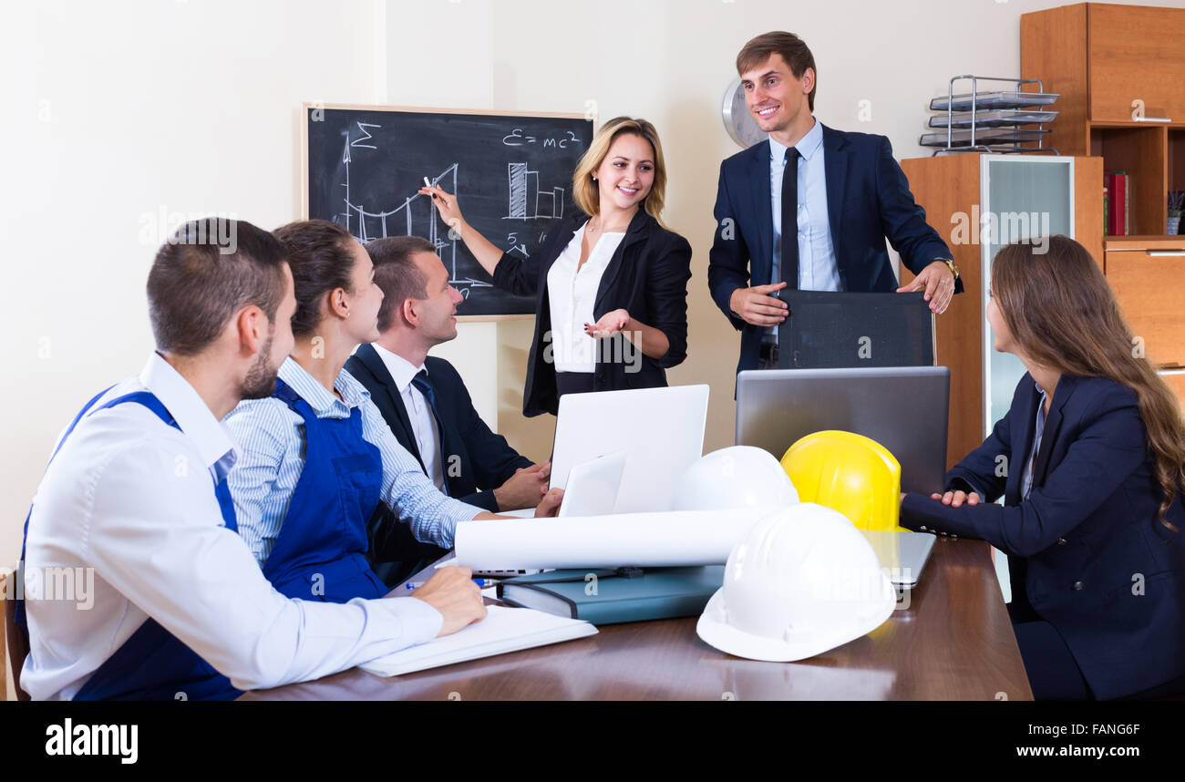 Team of architects and engineers having working meeting in office ...