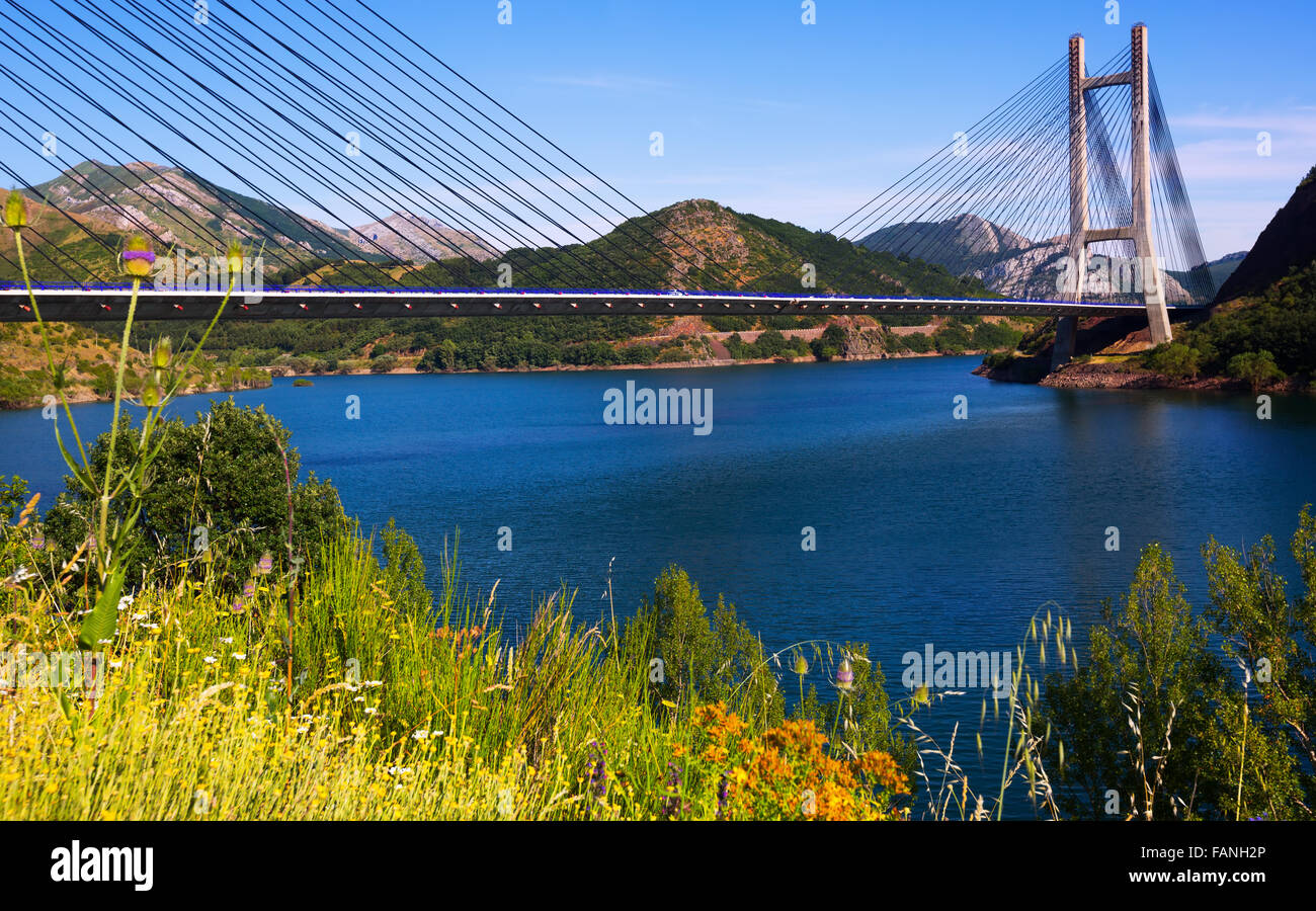 Cable-stayed bridge over lake in mountains of  Leon Stock Photo