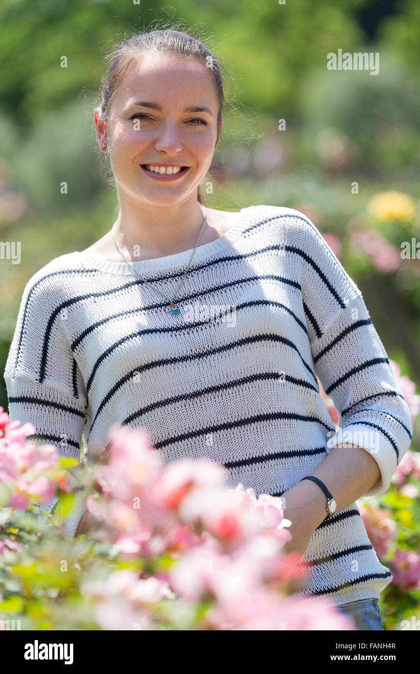 Outdoor portrait of smiling beautiful young female Stock Photo - Alamy