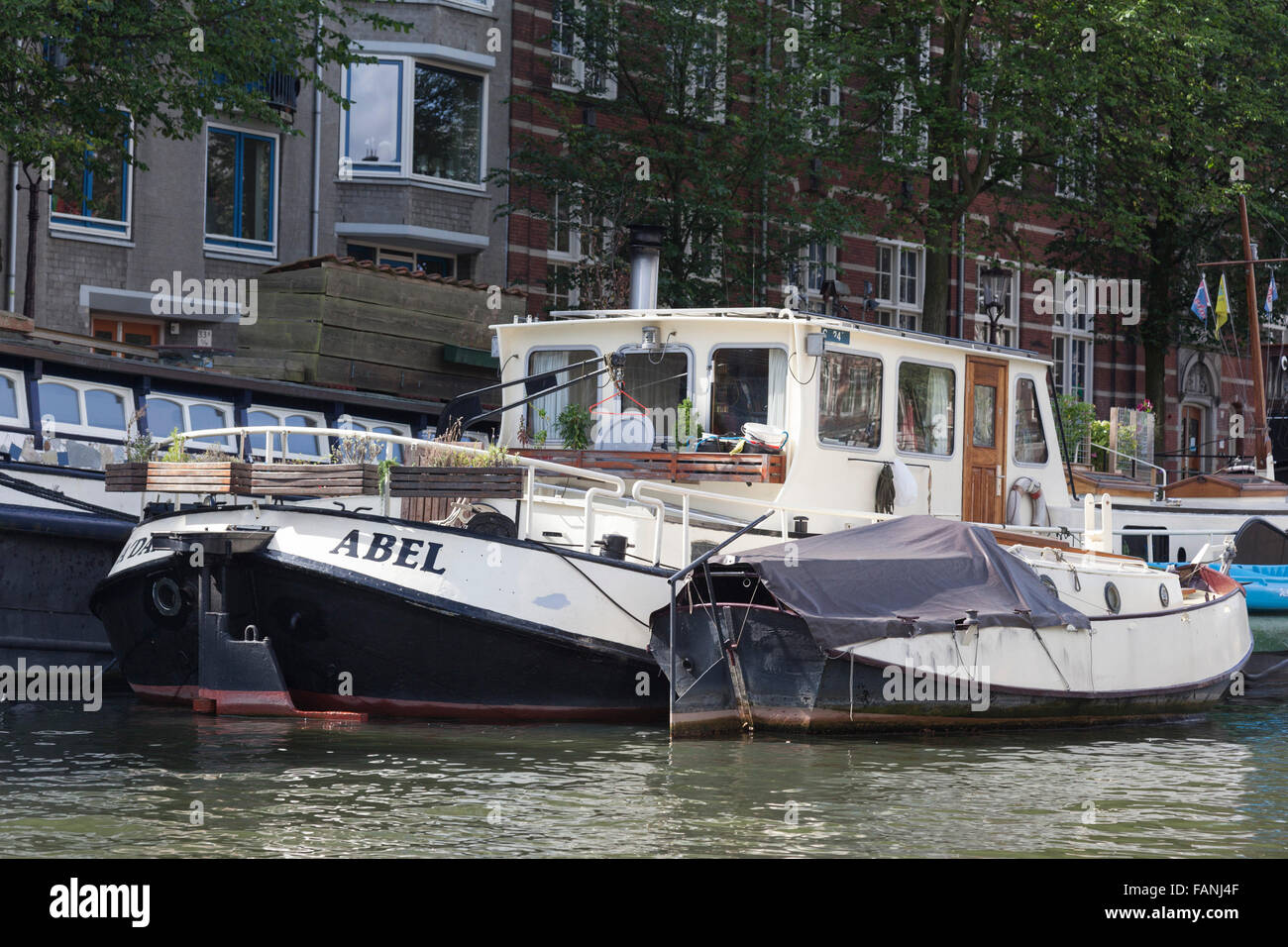 Houseboats on a canal, gracht, in Amsterdam, Holland, The Netherlands
