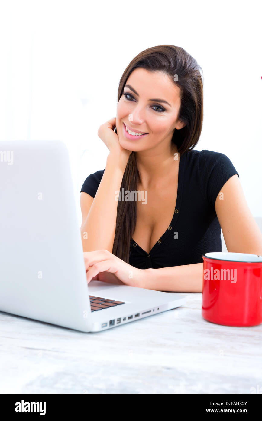 A young beautiful woman using a Laptop computer at home Stock Photo - Alamy