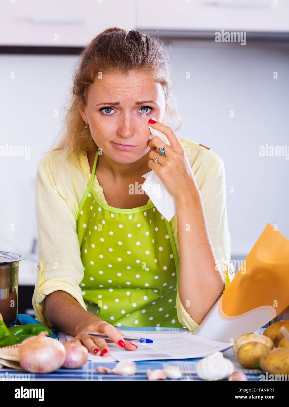 Sad girl reading banking statement and crying indoors Stock Photo - Alamy