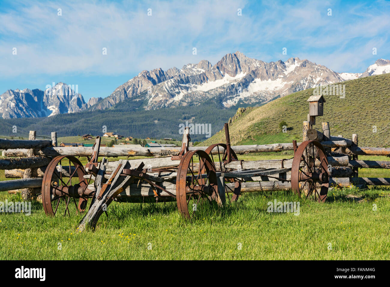 Idaho, Stanley, Sawtooth Mountains, antique farm wagon, split rail fence Stock Photo