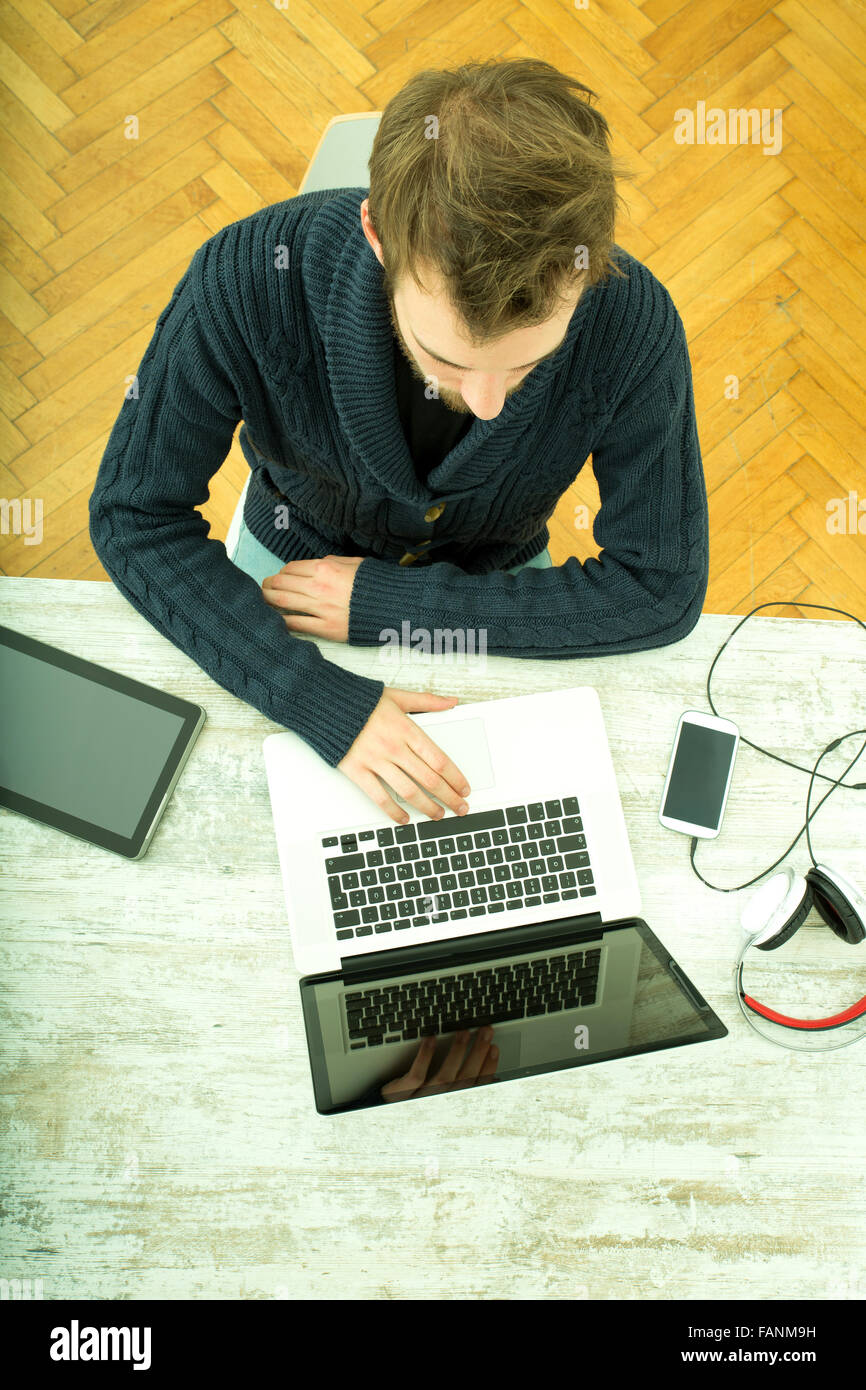 A young man using his laptop computer at home Stock Photo - Alamy