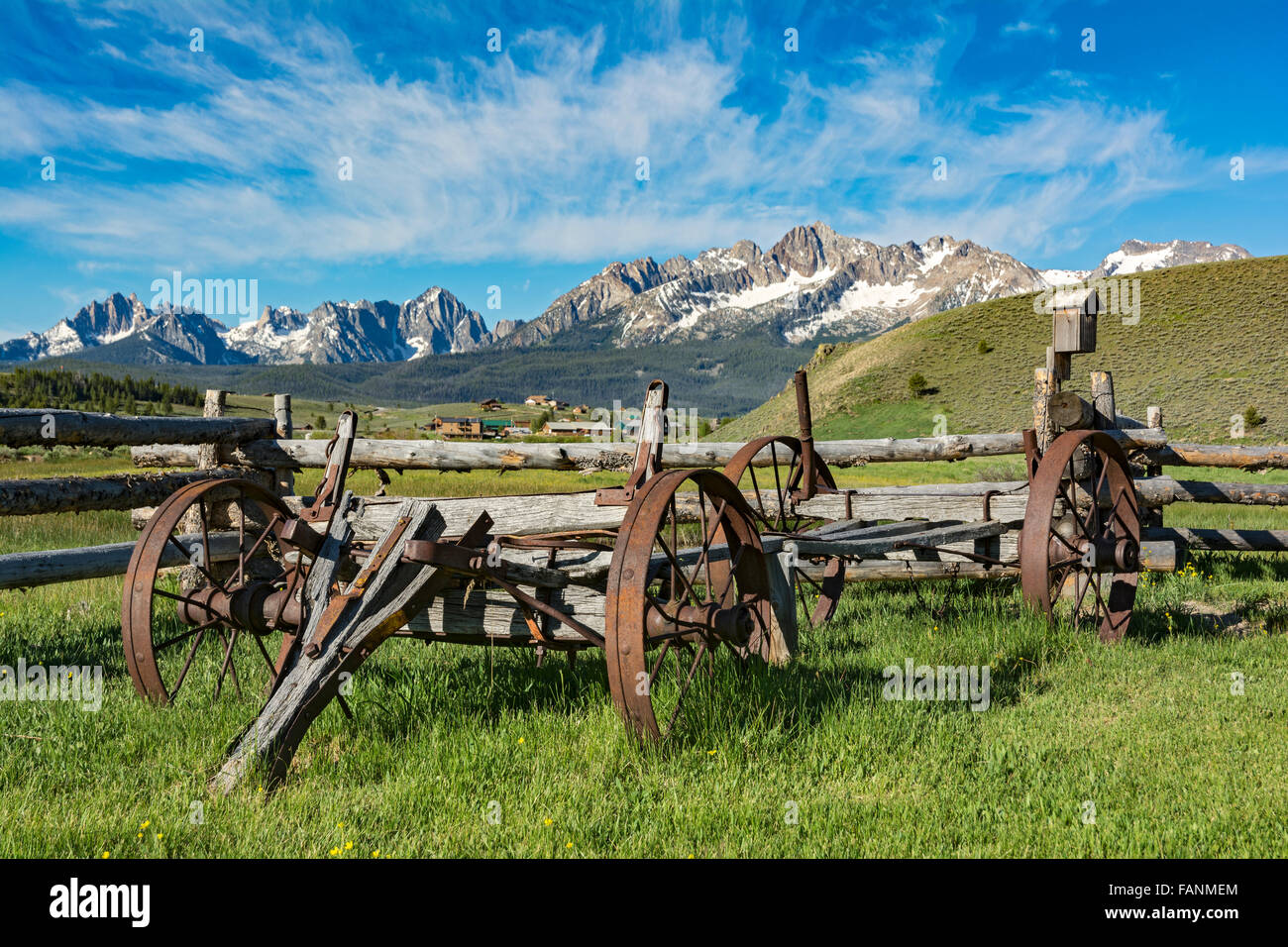 Idaho, Stanley, Sawtooth Mountains, antique farm wagon, split rail fence Stock Photo