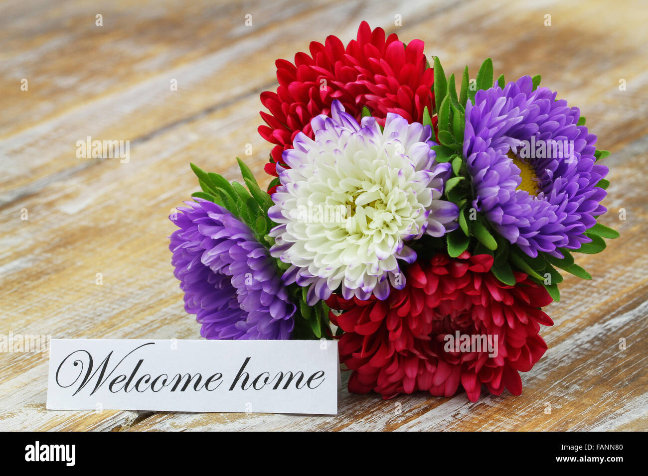 Rustic Welcome Flowers Welcome home card with colorful aster flowers bouquet on rustic wooden ...