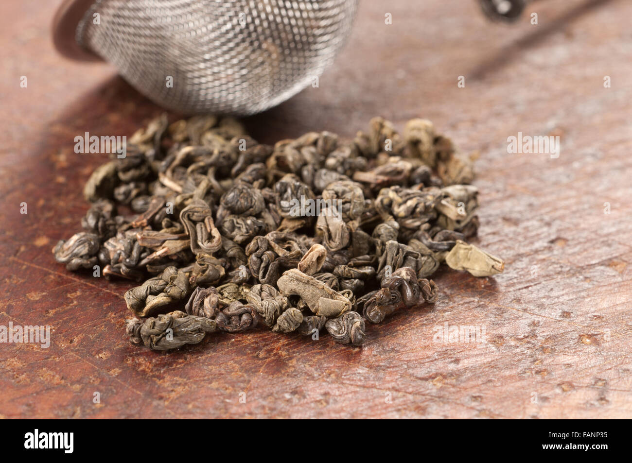 Green tea leaves on a timber board Stock Photo