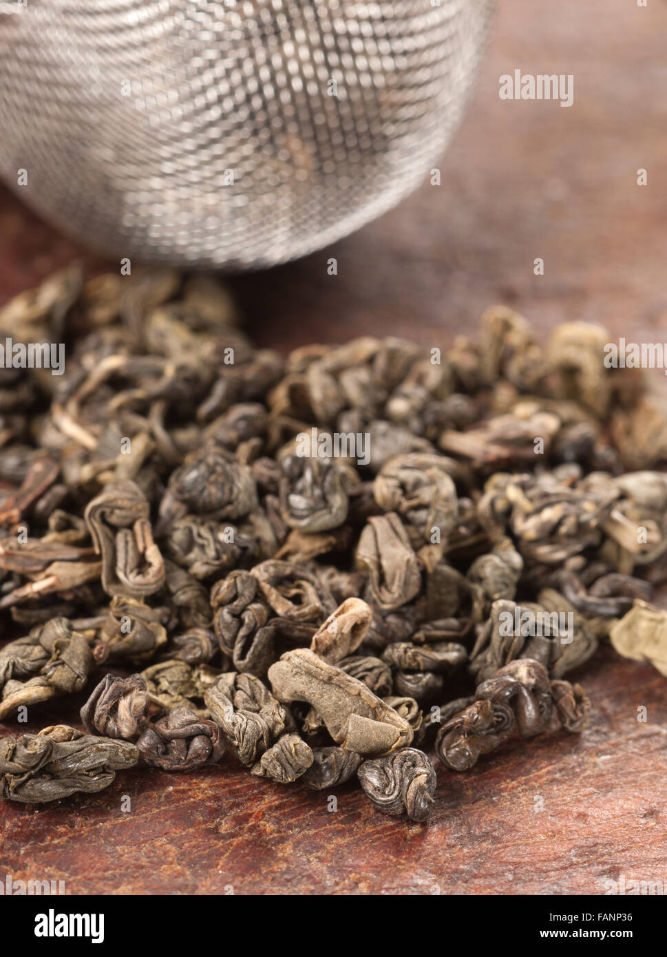 Green tea leaves on a timber board Stock Photo