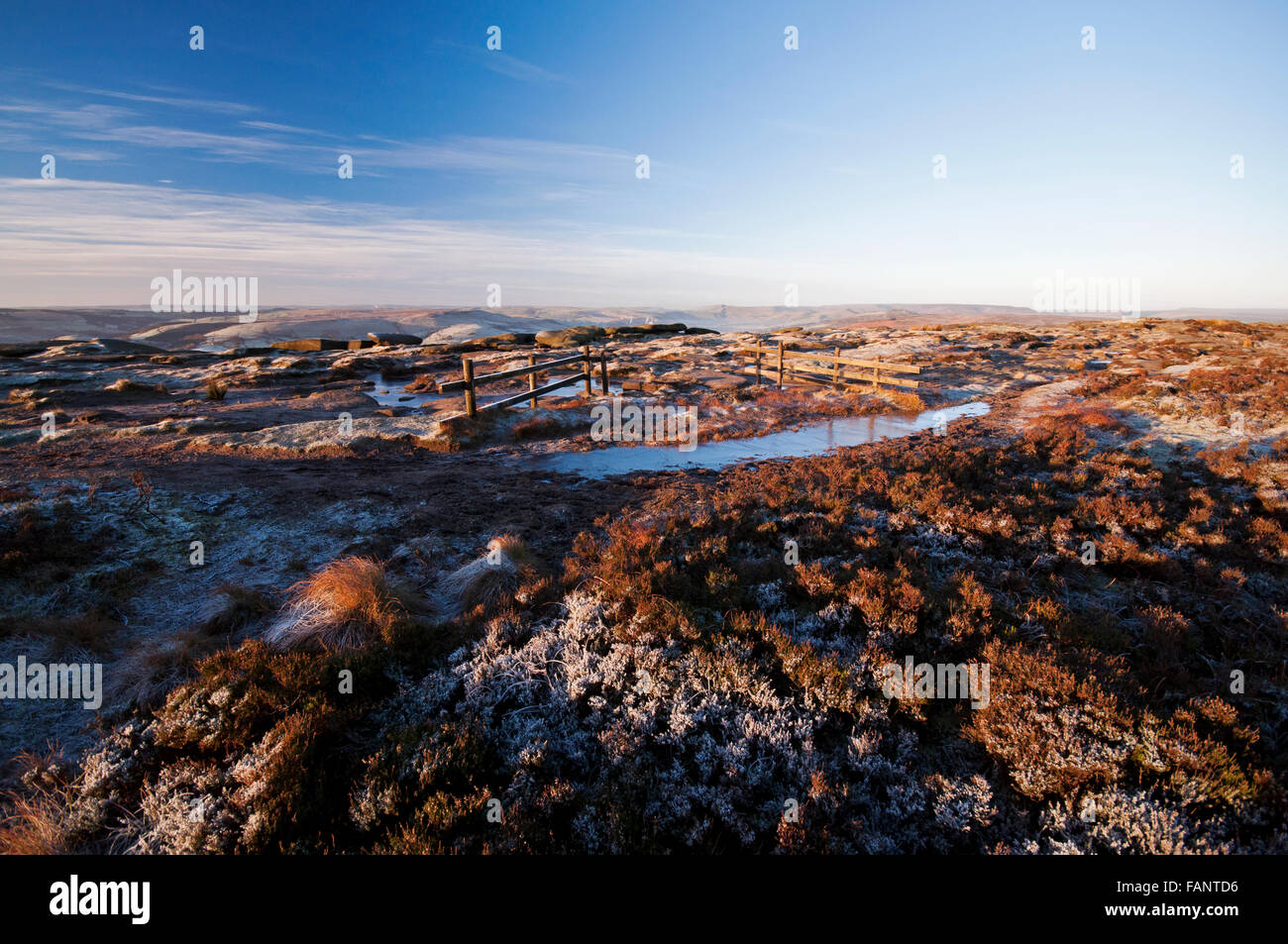 Looking out from Stanage Edge at sunrise on a frosty wintry morning in the Peak District National Park. Stock Photo