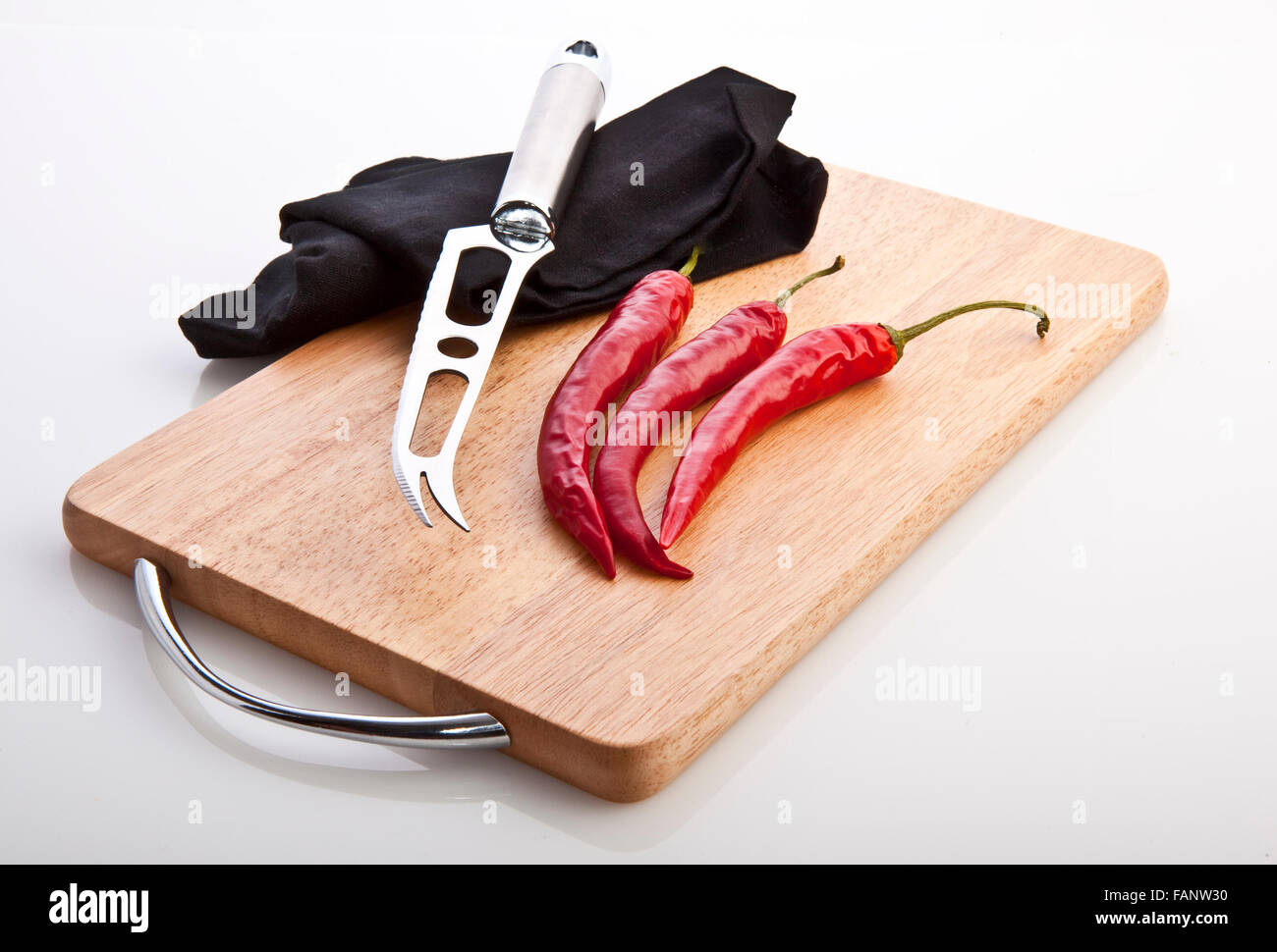 Red hot chili peppers on cutting board Stock Photo - Alamy