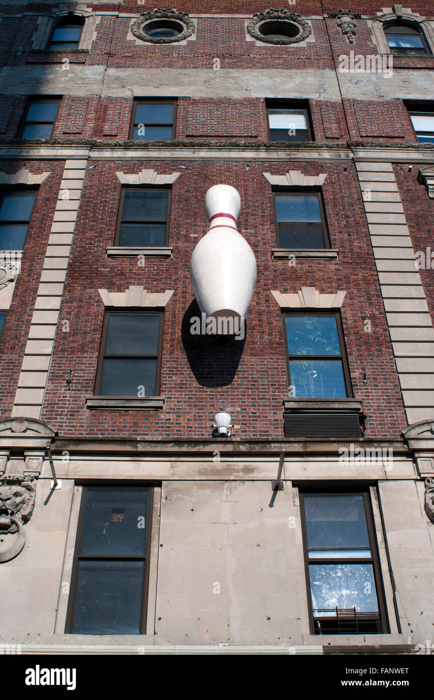 Alhambra Theatre Building, Harlem. Harlem lanes, New York, USA. A bowling pin and sign on the facade of a building advertise a bowling alley that is no longer there in the neighborhood of Harlem. Stock Photo