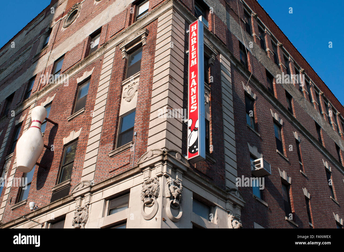 Alhambra Theatre Building, Harlem. Harlem lanes, New York, USA. A bowling pin and sign on the facade of a building advertise a bowling alley that is no longer there in the neighborhood of Harlem. Stock Photo