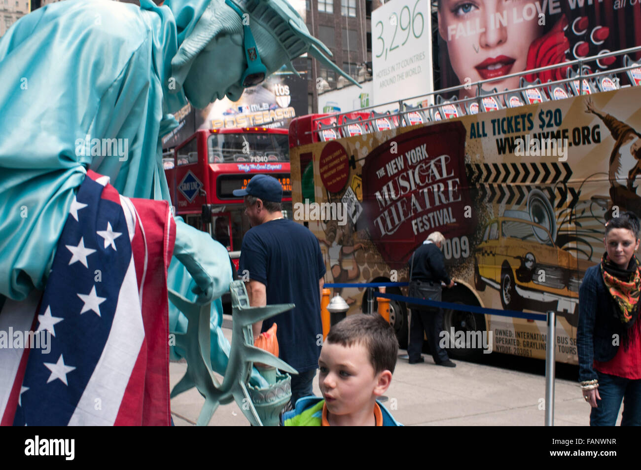 NEW YORK, A human statue dressed in Statue of Liberty is pictured with a child near Times Square. If we want good photos of Time Stock Photo