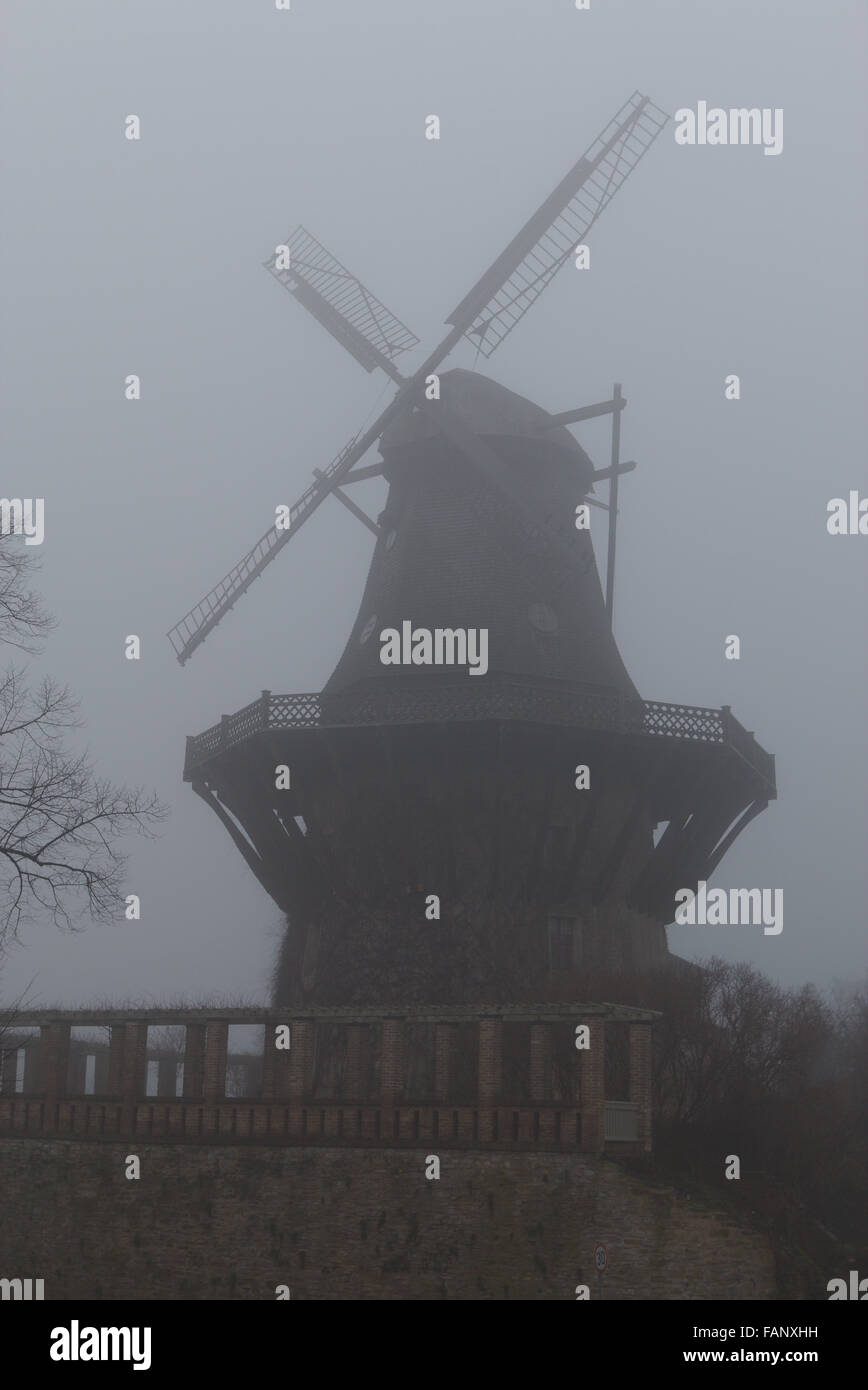 Old windmill in Potsdam during a foggy, winter day Stock Photo