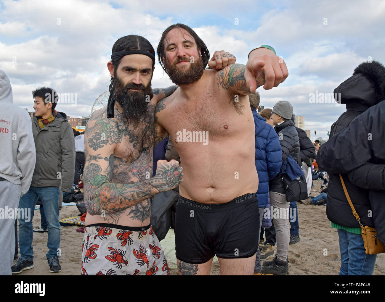 Two men posing on the beach in Coney Island, Brooklyn on New Years day after their swim with the Polar Bear Club. Stock Photo