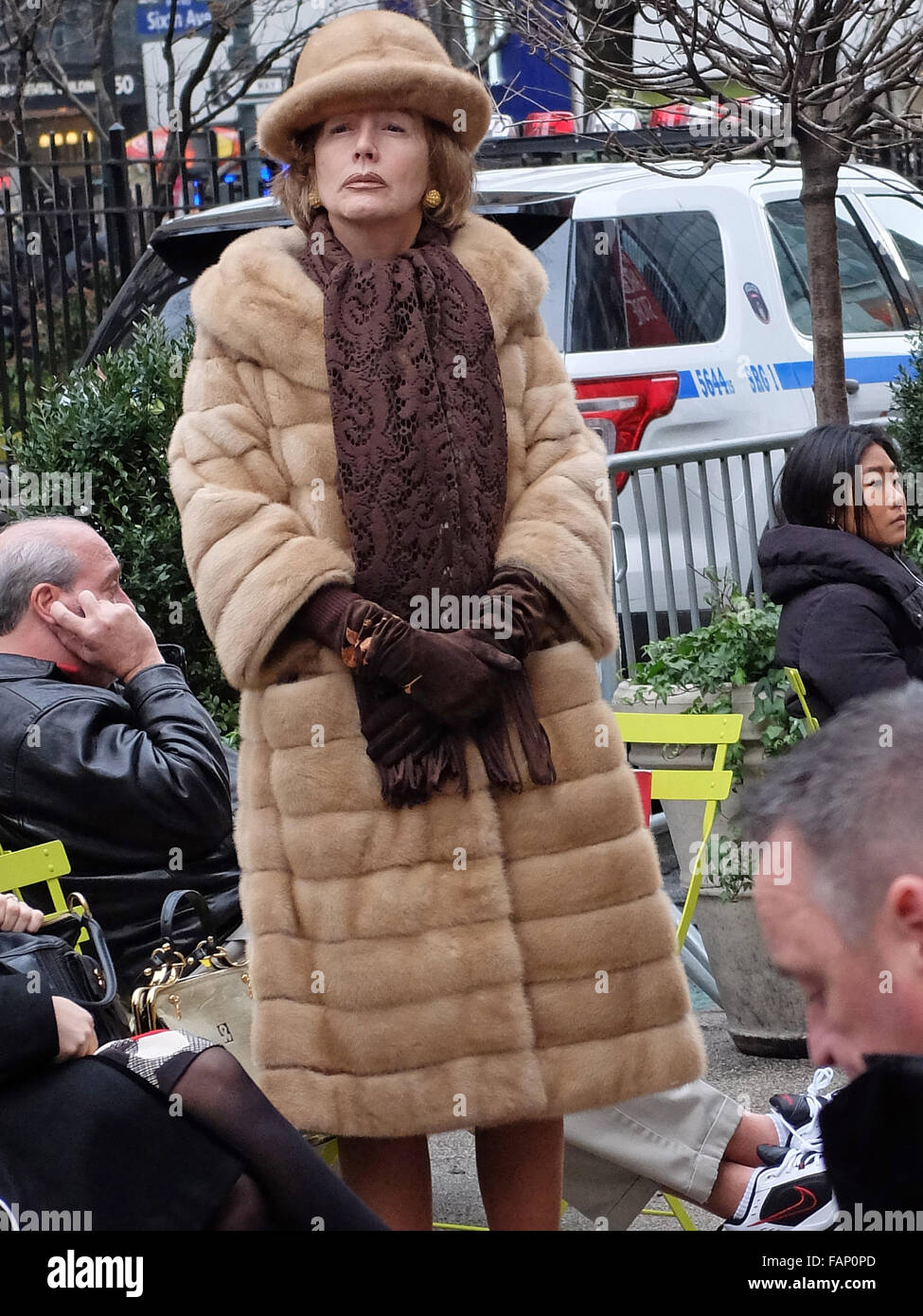 A woman in a matching coat and hat that appear to be real fur. At Herald Square in Midtown Manhattan, New York City. Stock Photo