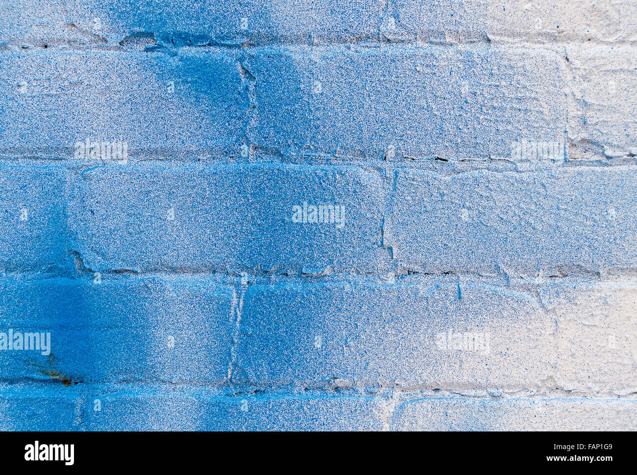 Closeup of white brick wall with blue spray stains Stock Photo Alamy