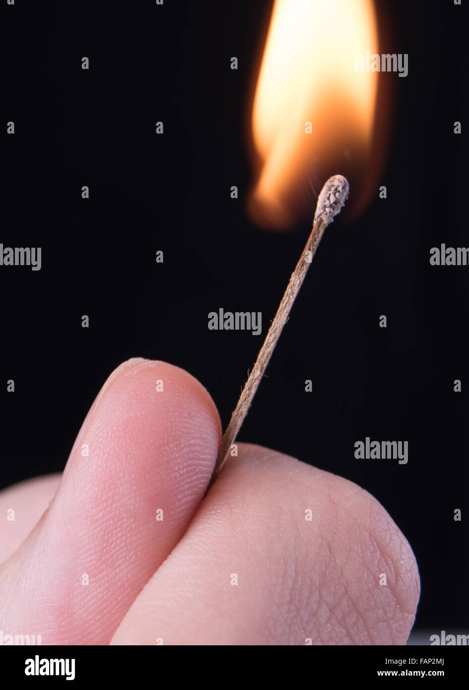 fingers holding a match on fire Stock Photo Alamy
