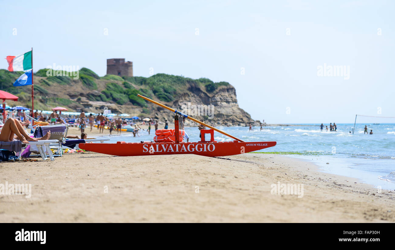 Rome, Italy - August 12, 2015: people having fun and relaxing in a italian beach, a red rescue boat in the front Stock Photo