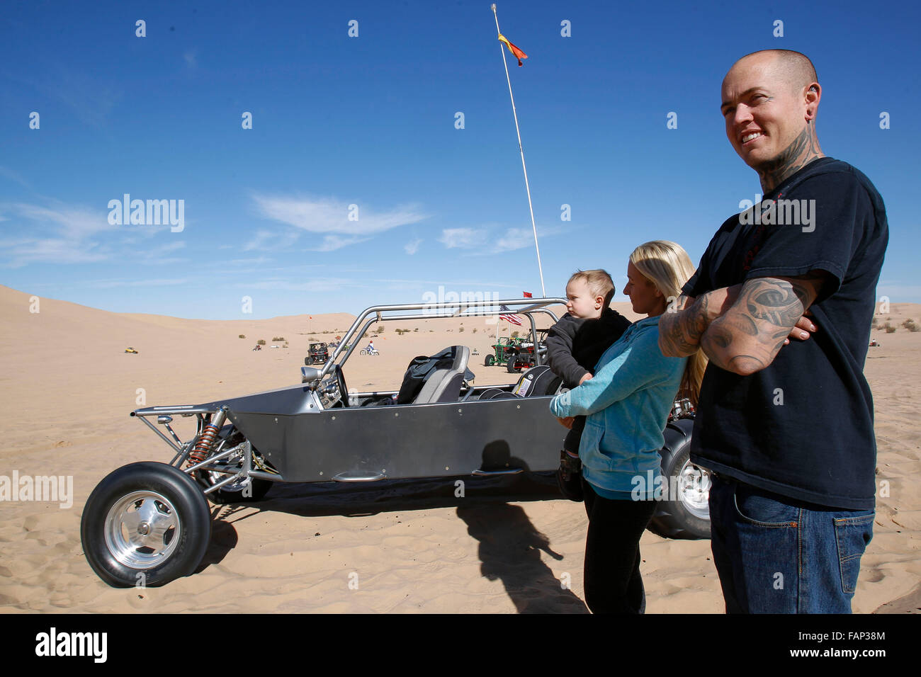 San Diego, USA. 1st Jan, 2016. SAN DIEGO, January 1, 2016 | Zack Evans, his wife Corey, and son Gunther, 1, who are from Menifee, stand next to their side-by-side as they watch off-road vehicles go up Oldsmobile Hill at the Imperial Sand Dunes on Friday. | -Mandatory Photo Credit: Photo by Hayne Palmour IV/San Diego Union-Tribune, LLC © Hayne Palmour Iv/U-T San Diego/ZUMA Wire/Alamy Live News Stock Photo